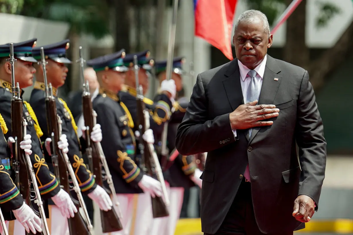 U.S. Secretary of Defense Lloyd Austin inspects honor guards during his arrival at Camp Aguinaldo, in Quezon City