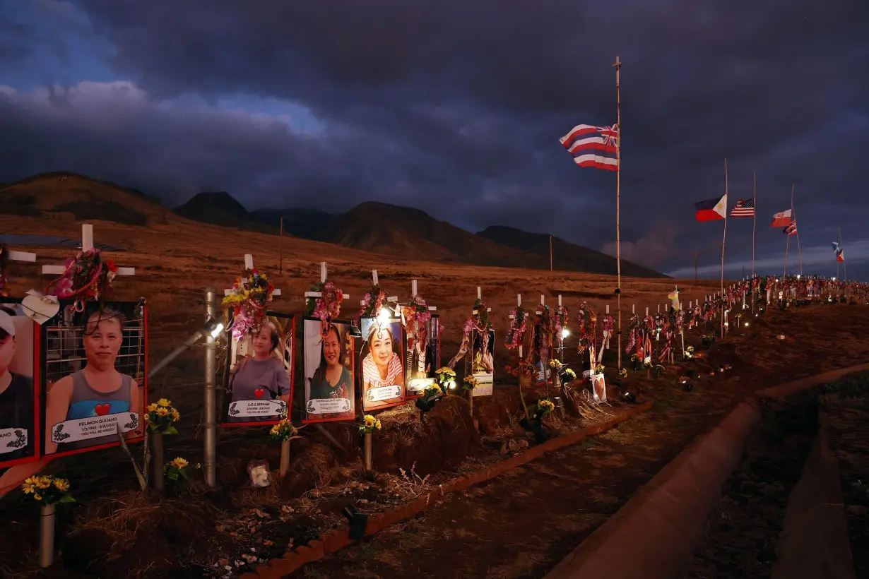 Pictures and crosses are displayed at a public hillside memorial to Lahaina wildfire victims on August 1, in Lahaina, Hawaii as August 8 marks the one-year anniversary of the Maui wildfires which killed 102 people and devastated the historic community of Lahaina in West Maui.