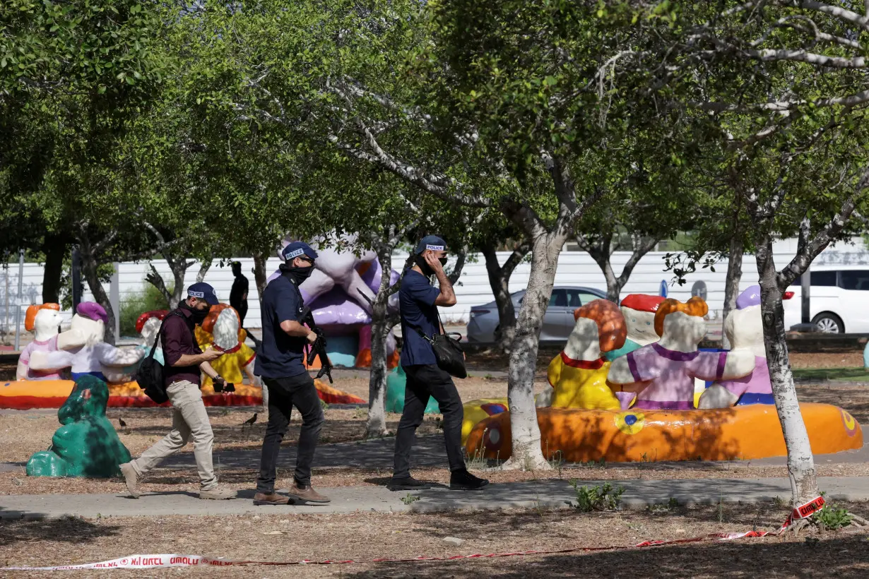 Israeli emergency responders work at the scene of a suspected stabbing attack in Holon