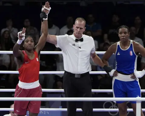 Boxer Cindy Ngamba becomes first athlete competing as a refugee to clinch an Olympic medal