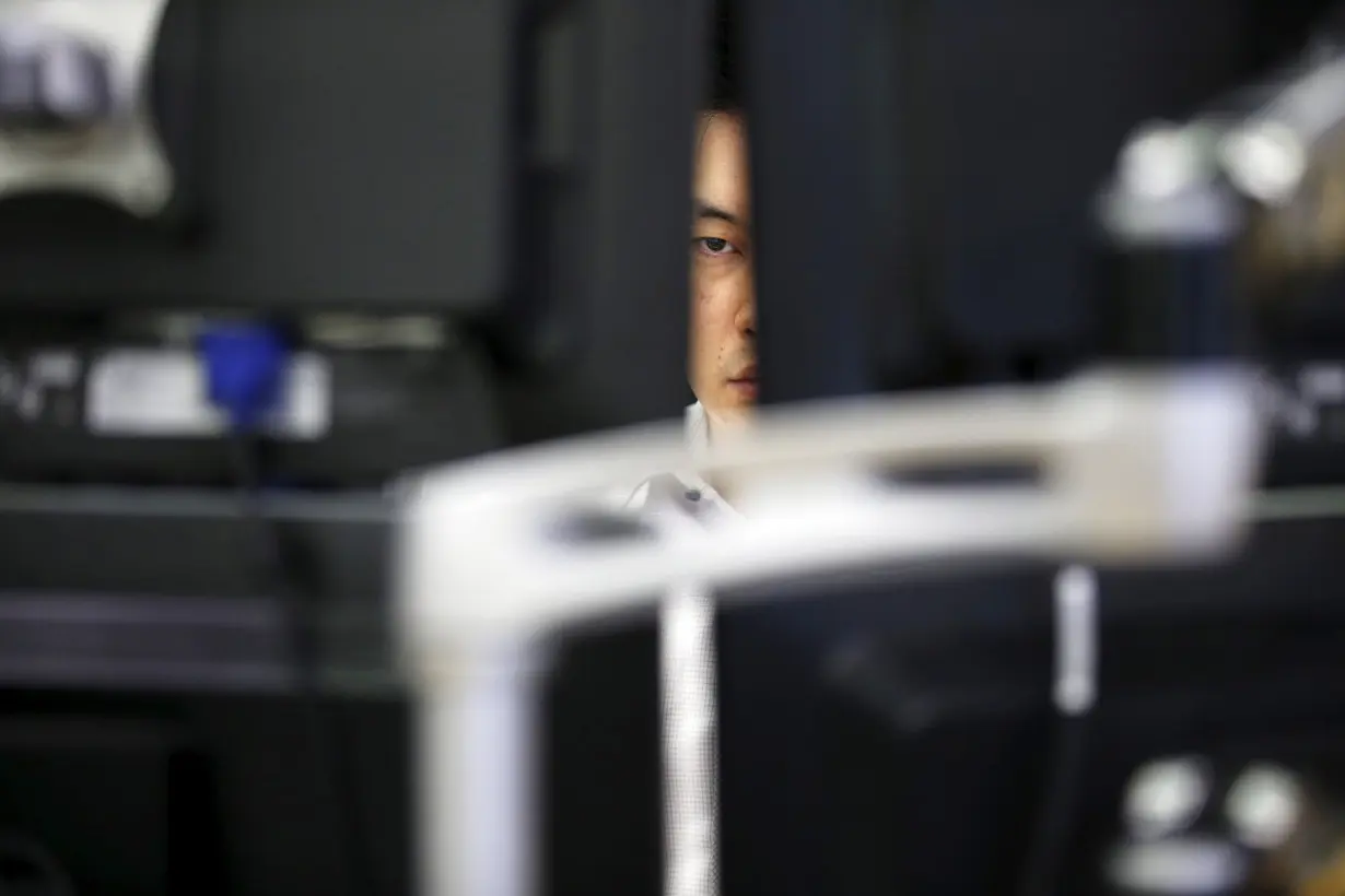 A currency dealer works at a dealing room of a bank in Seoul