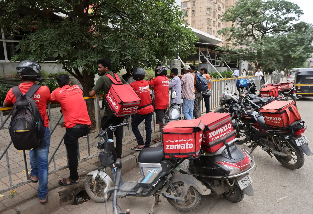 File Photo: Gig workers wait in line to collect their delivery order outside a mall in Mumbai,