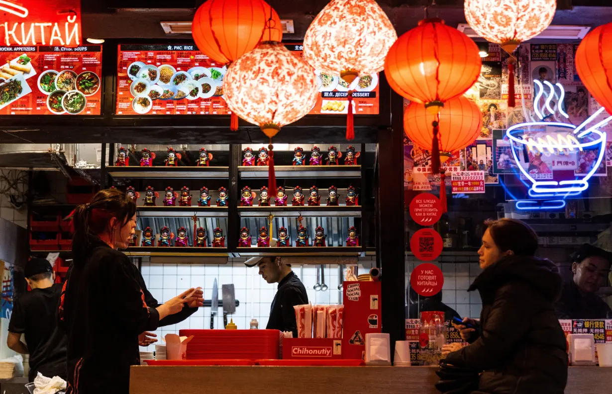 A woman looks on as she waits at a Chinese restaurant in Moscow