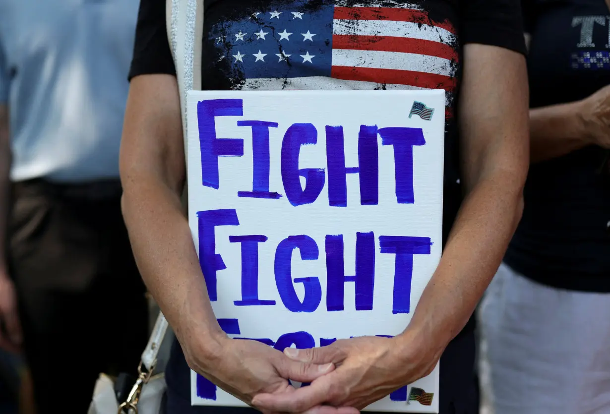 FILE PHOTO: Supporters of former U.S. President Donald Trump attend a prayer vigil hosted by Turning Point Action near the venue for the RNC, in Milwaukee