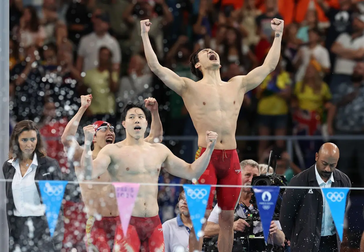 China's swim team celebrates victory in the men's 4x100m medley relay final at the Paris Olympics on August 4, in Nanterre, France.