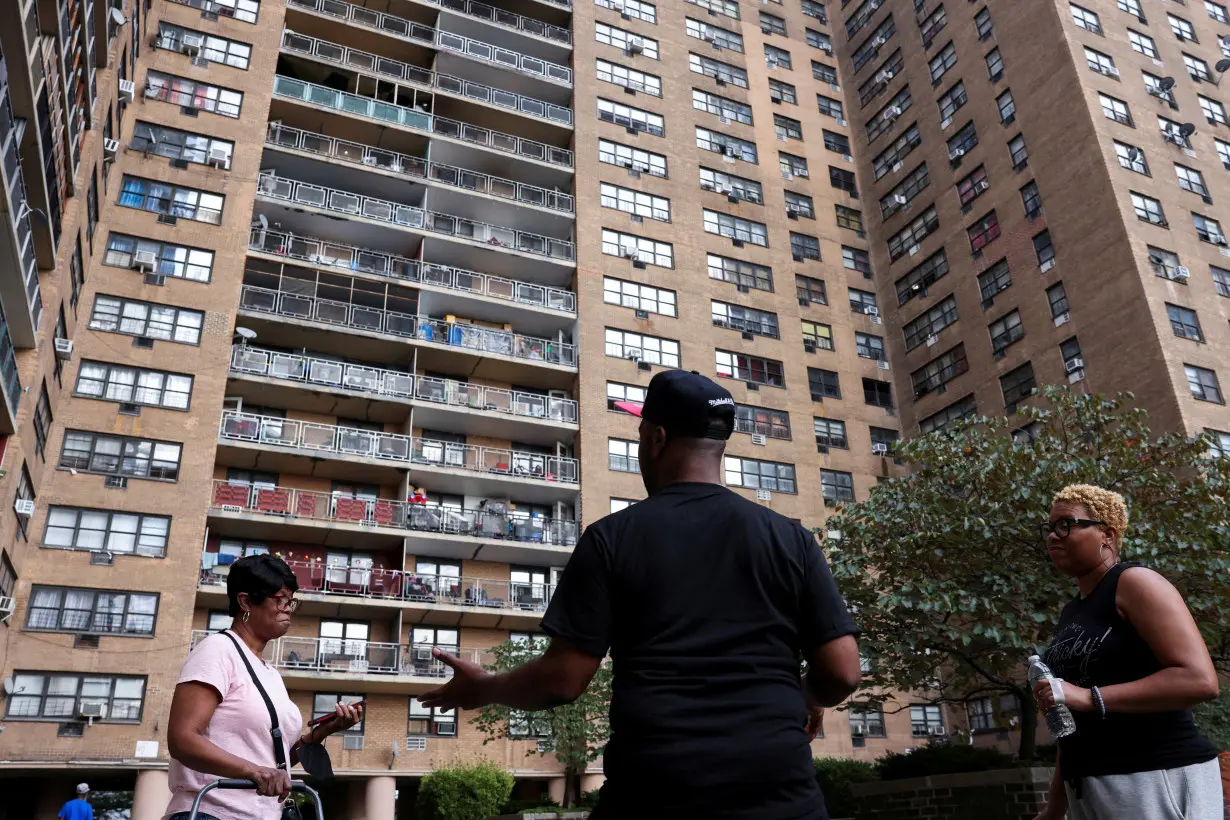 FILE PHOTO: Anthony Gay converses with his neighbors about his struggle with air conditioning at 11 McKeever Place in New York