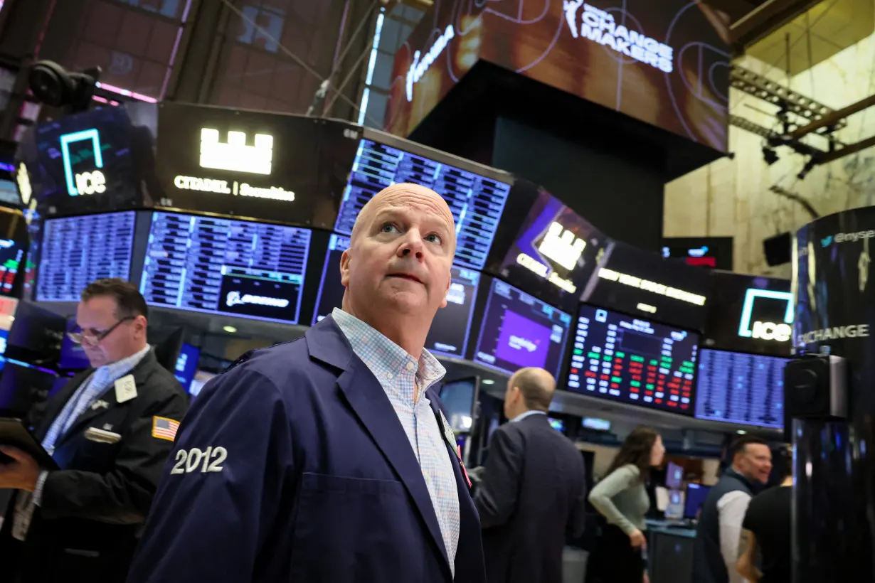 Traders work on the floor of the NYSE in New York