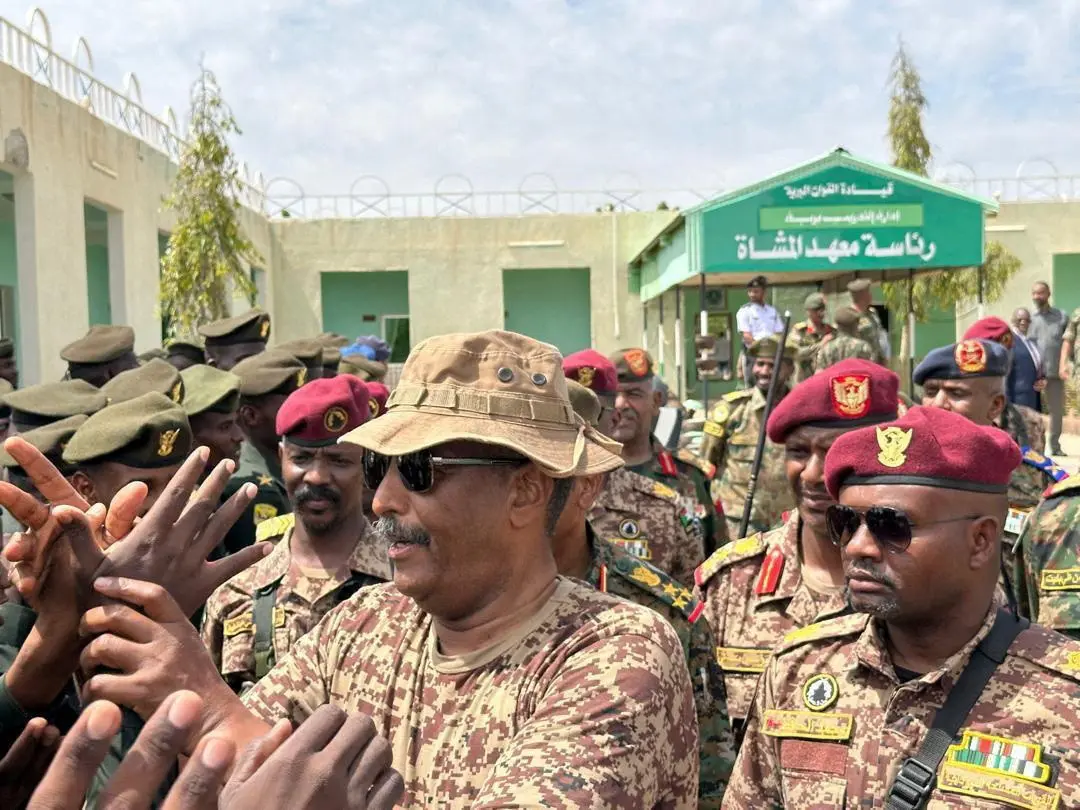 Head of Sudan's armed forces Abdel Fattah al-Burhan greets officers after drone strike hit army base, in Gebit