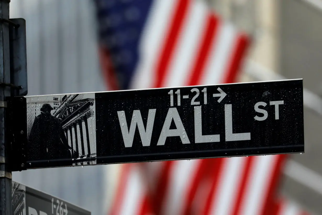 FILE PHOTO: A sign for Wall Street outside the New York Stock Exchange in New York, U.S.