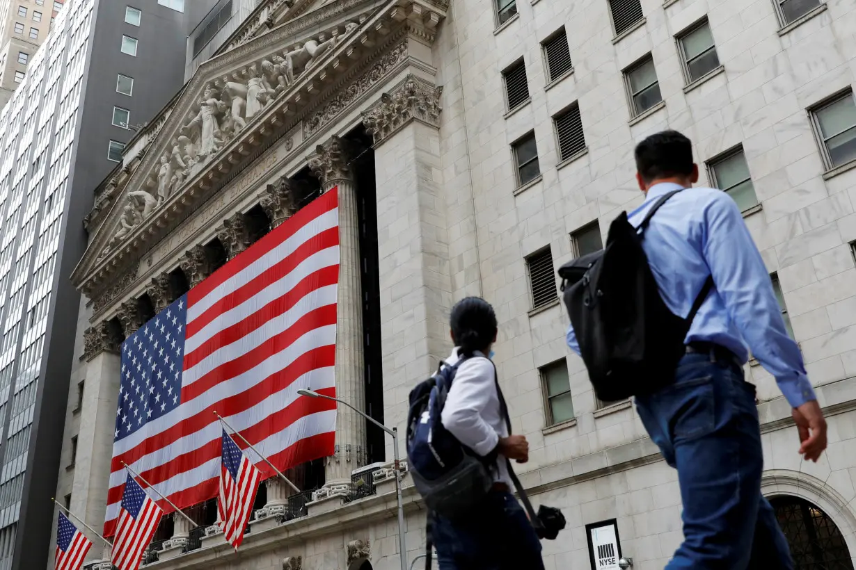 People walk by the New York Stock Exchange (NYSE) in Manhattan, New York City