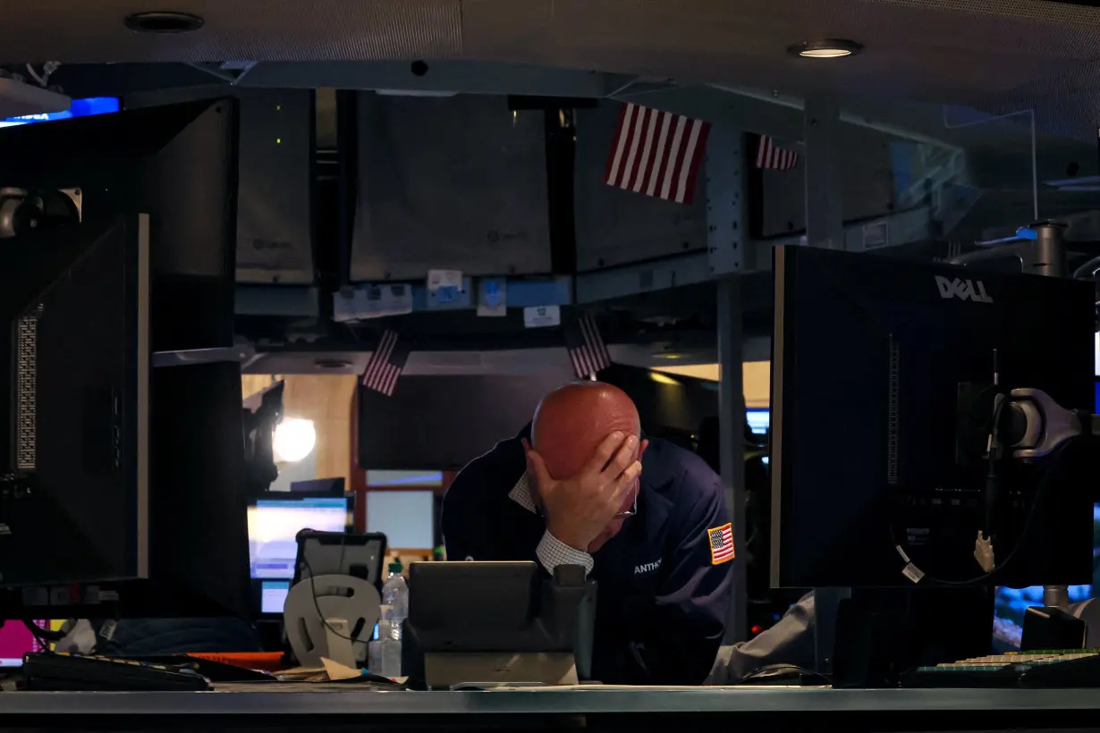 Traders work on the floor of the NYSE in New York