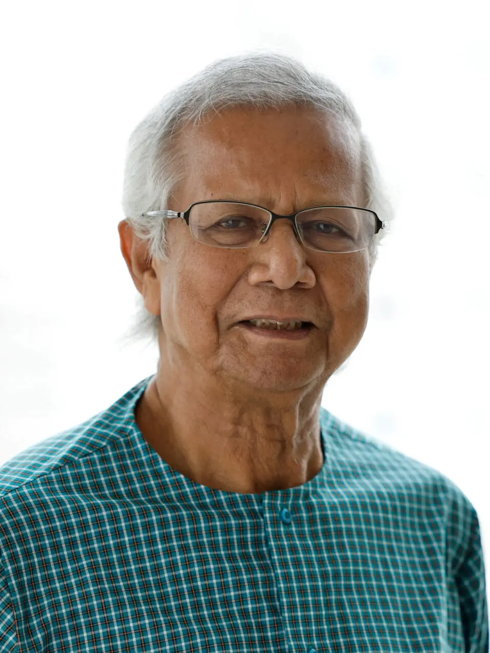 FILE PHOTO: Bangladeshi Nobel Peace Prize winner Dr. Muhammad Yunus poses for photo during an interview with Reuters in his office, in Dhaka