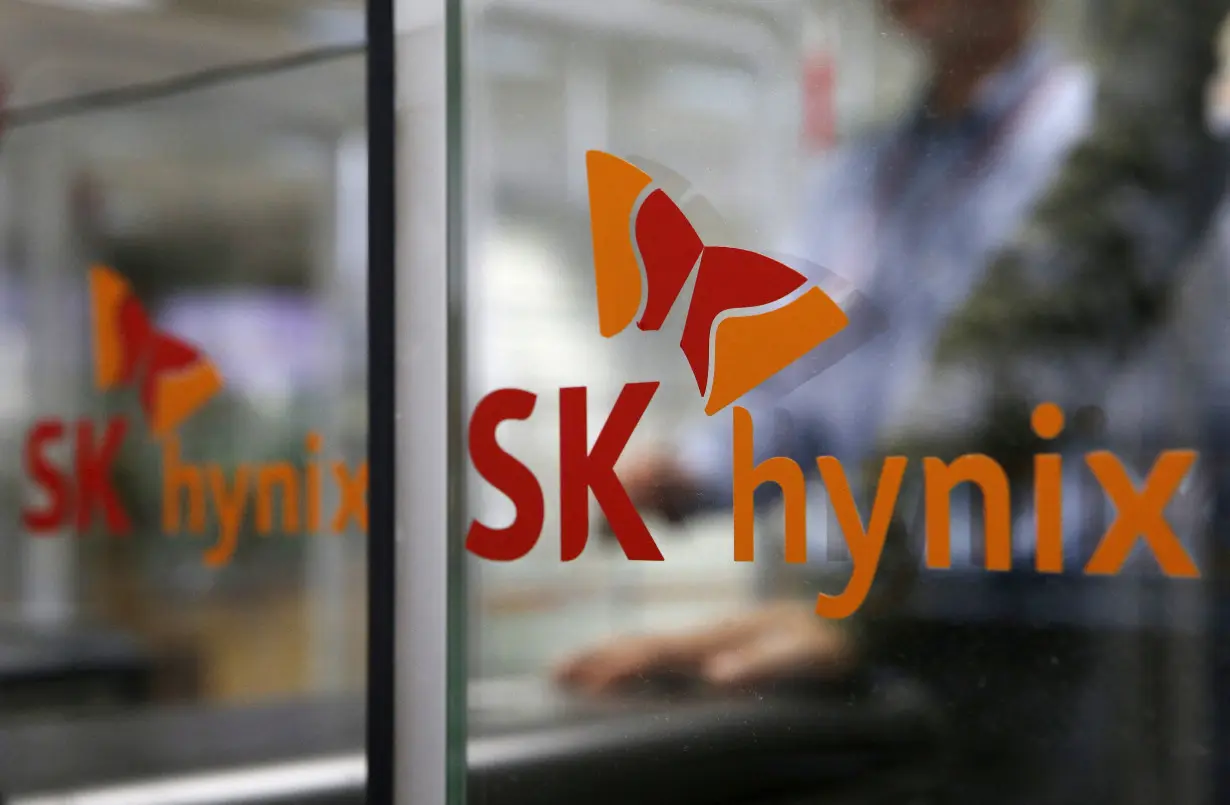 FILE PHOTO: Employee walks past the logo of SK Hynix at its headquarters in Seongnam