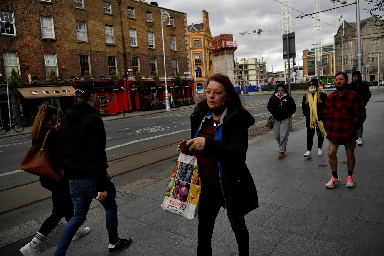 People walk along a street in Dublin