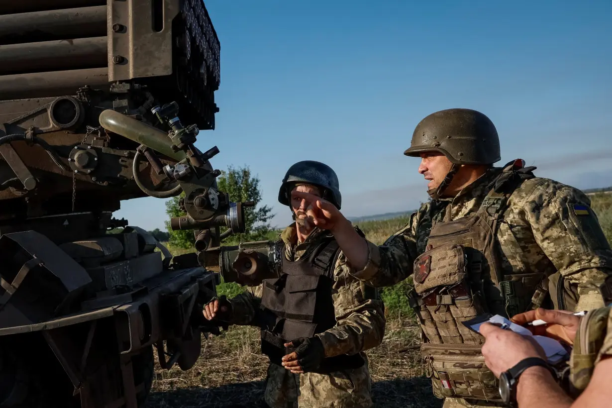 Ukrainian service members prepare to fire a RM-70 Vampire multiple launch rocket system towards Russian troops, at a position near a front line in Donetsk region