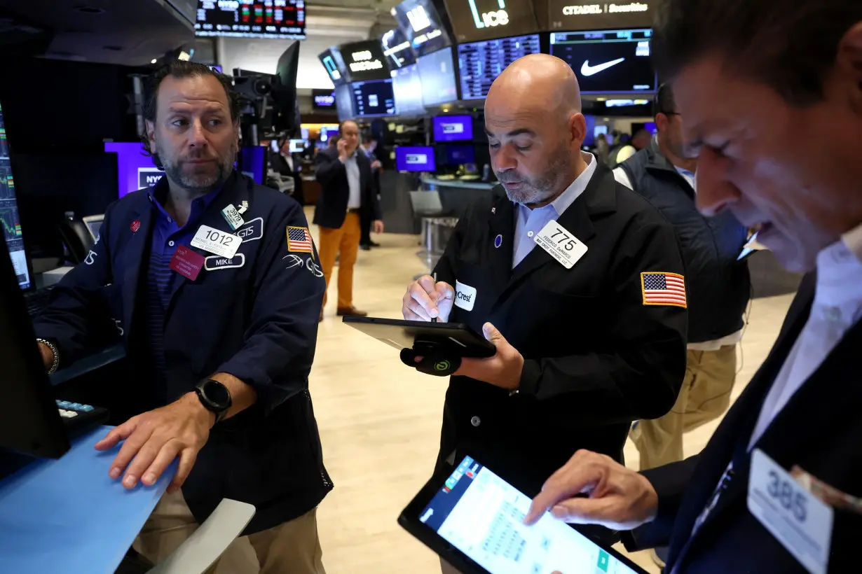 Traders work on the floor of the NYSE in New York