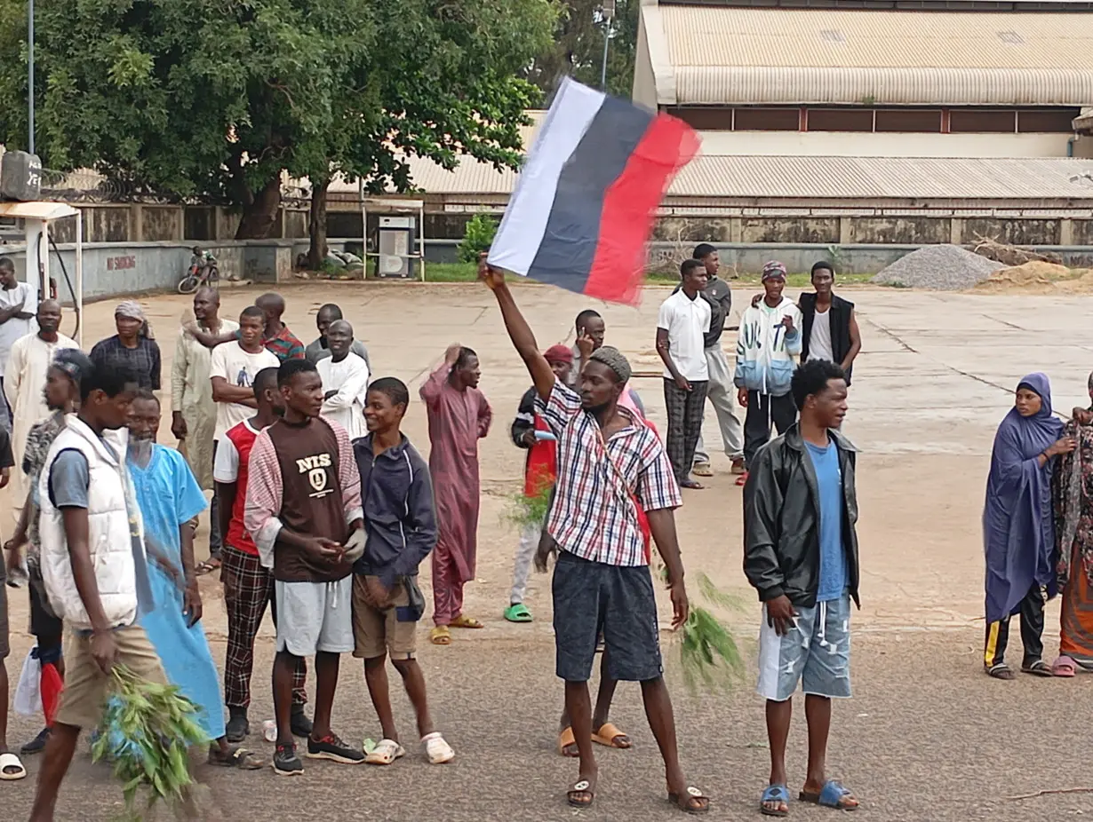 Demonstrators hold Russian flag as Nigerians continue to protest against economic hardship, in Kaduna state