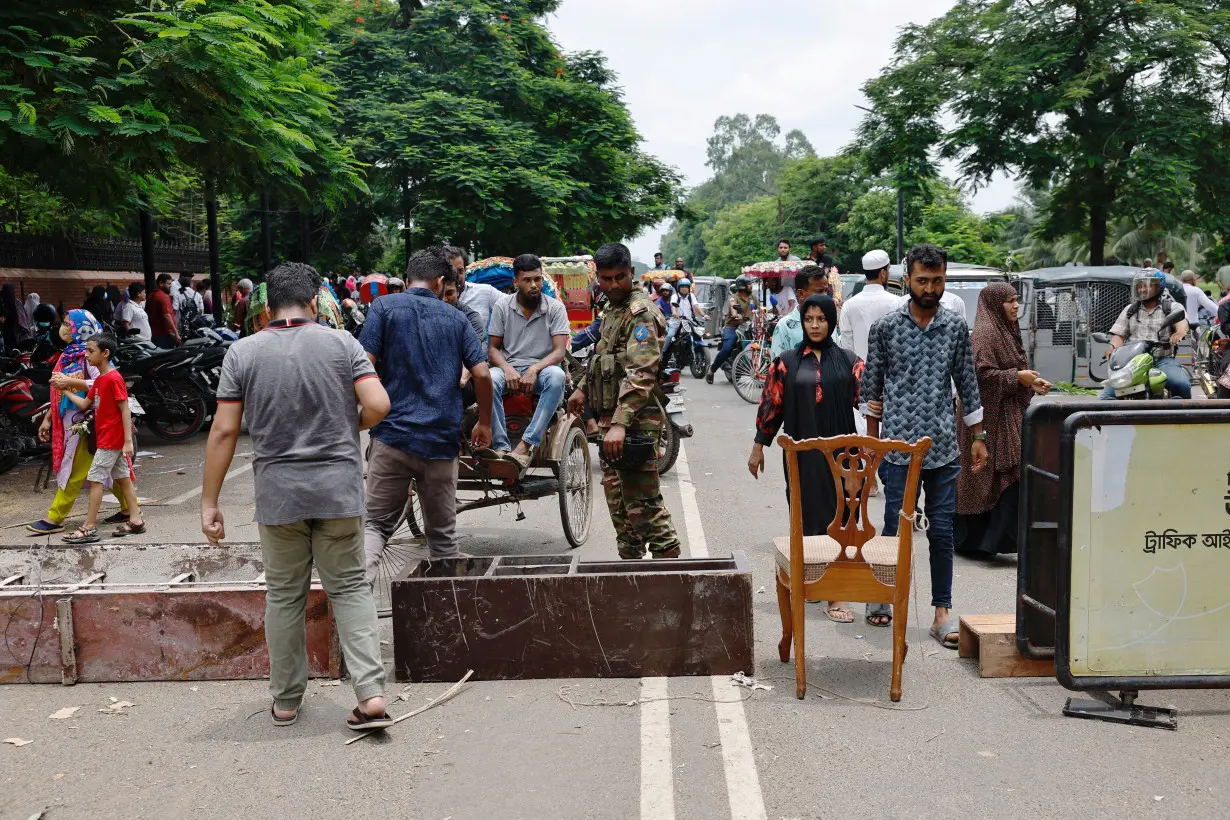 Army member blocks a road at the entrance of the Ganabhaban after Bangladeshi PM Hasina's resignation in Dhaka