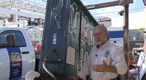 Business owner restoring historic neon signs damaged by monsoon