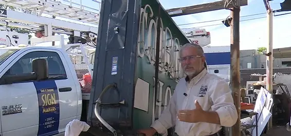 Business owner restoring historic neon signs damaged by monsoon