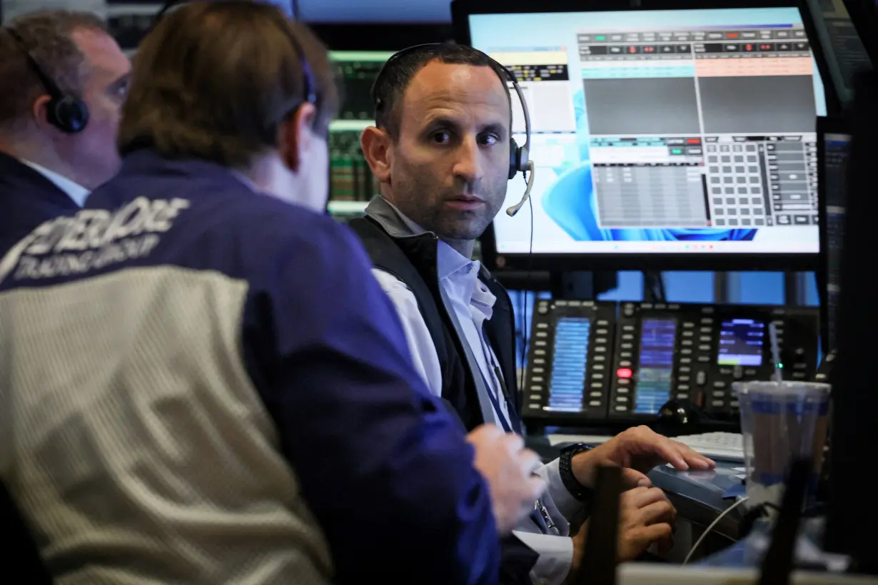 Traders work on the floor of the NYSE in New York