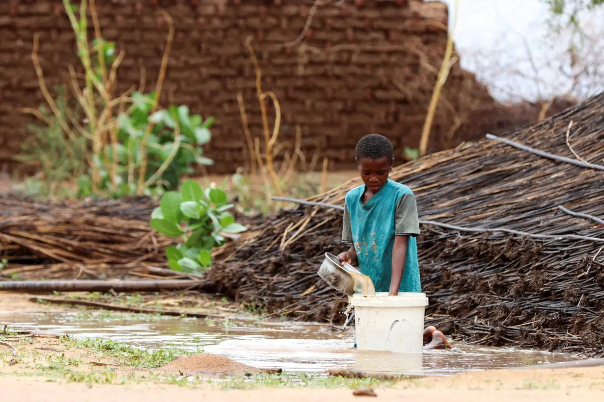 FILE PHOTO: Displaced Sudanese child pours water at Zamzam camp in North Darfur