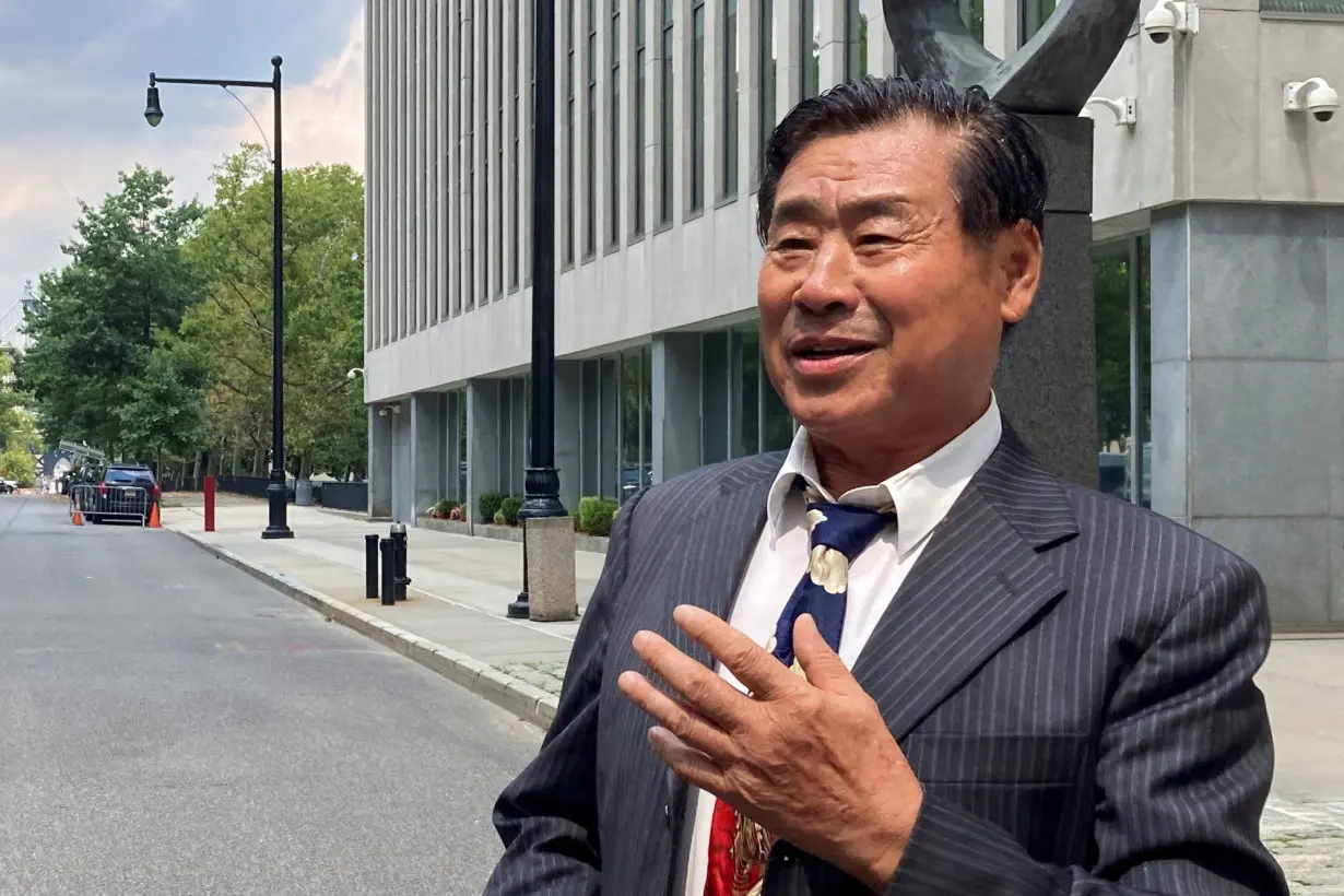 Chinese-American academic Wang Shujun speaks to the press after being convicted in Brooklyn federal court on charges of acting as an illegal agent of China's government, in New York