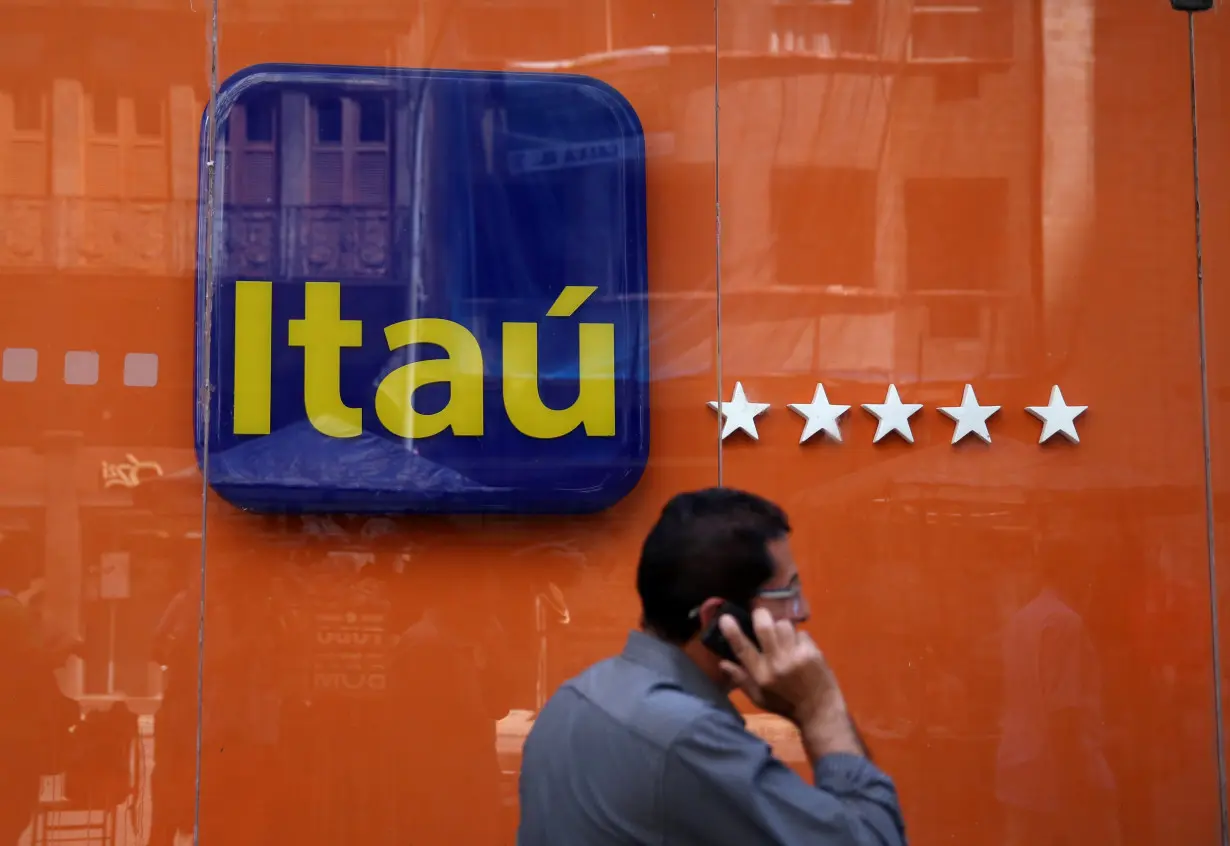 A man walks past an Itau Unibanco logo in Rio de Janeiro, Brazil