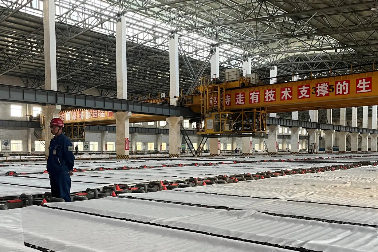 FILE PHOTO: Employees work at a copper smelter in Yantai