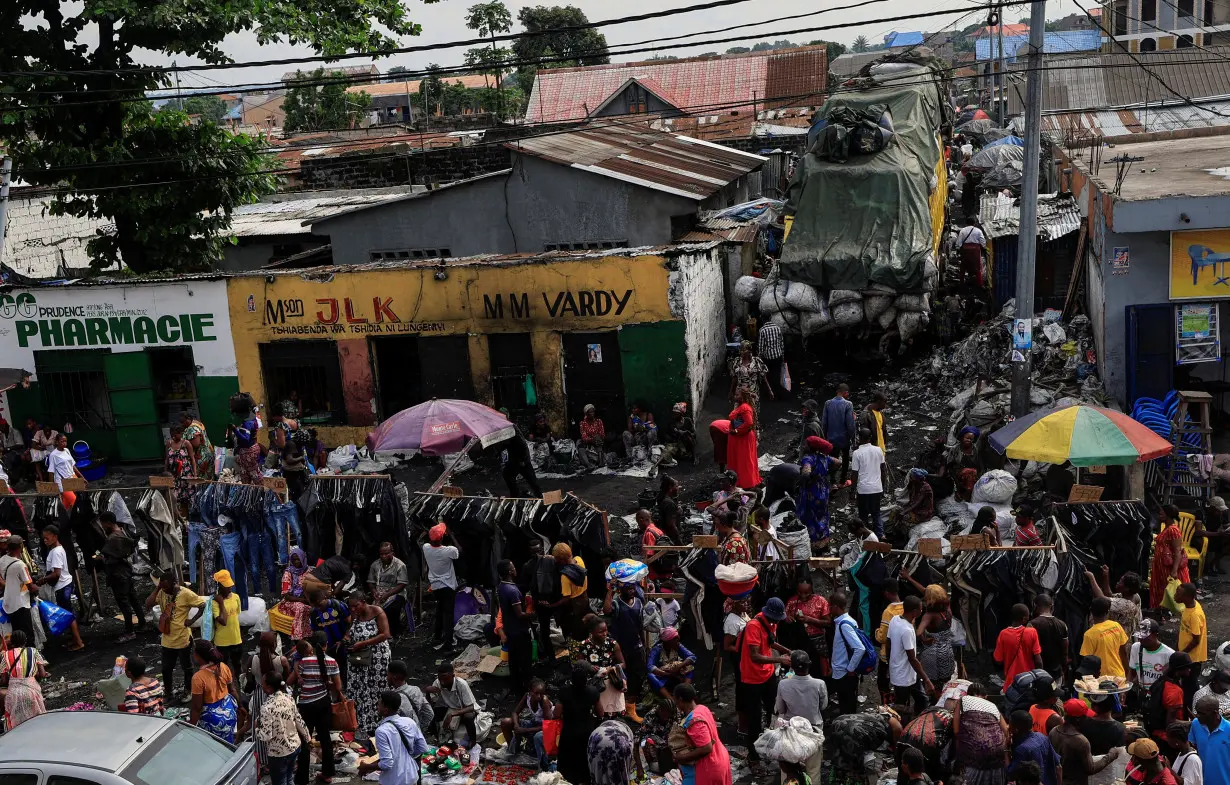 People shop at a public market, ahead of the parliamentary and presidential elections that are scheduled for December 20, in Kinshasa