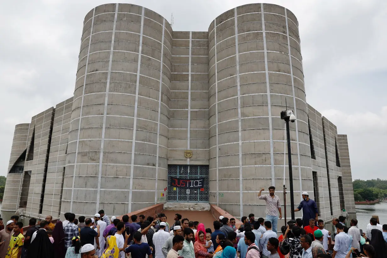 People gather outside the parliament building, after Bangladeshi PM Hasina's resignation, in Dhaka