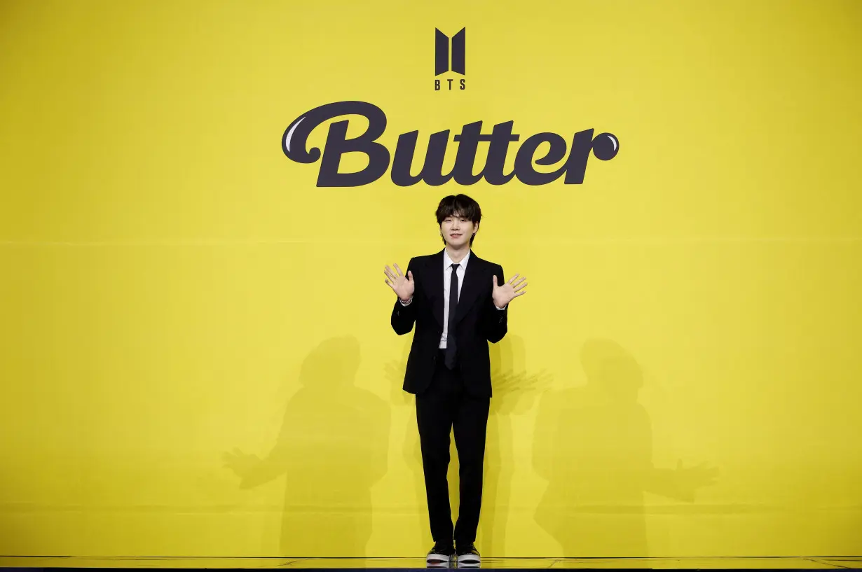 FILE PHOTO: K-pop boy band BTS member Suga poses for photographs during a photo opportunity promoting their new single 'Butter' in Seoul