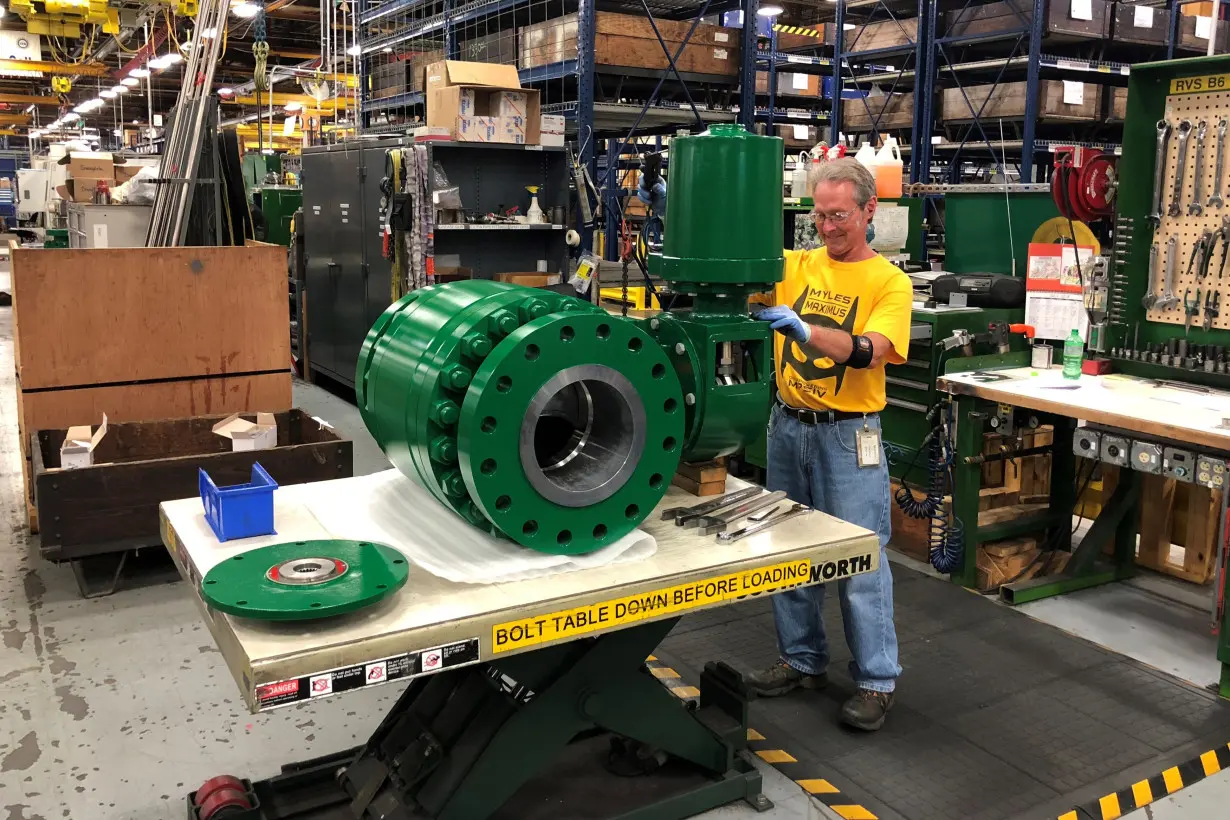 A worker assembles an industrial valve at Emerson Electric Co.'s factory in Marshalltown Iowa