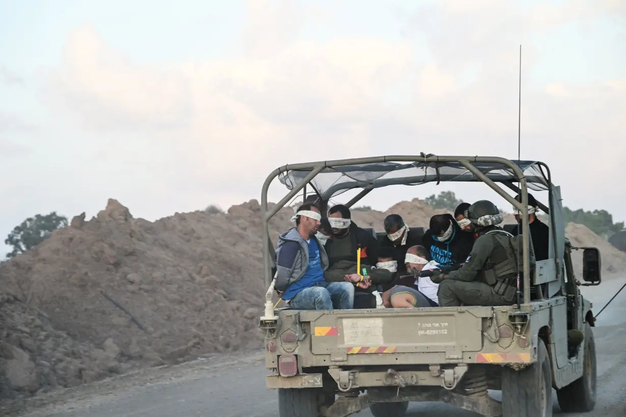 Israel's military transports Palestinian detainees from the Gaza Strip, amid the ongoing conflict between Israel and the Palestinian Islamist group Hamas, near Israel's border with Gaza