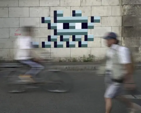 Mystery Paris street artist 'Invader' glues up new work to celebrate Olympics and delight fans