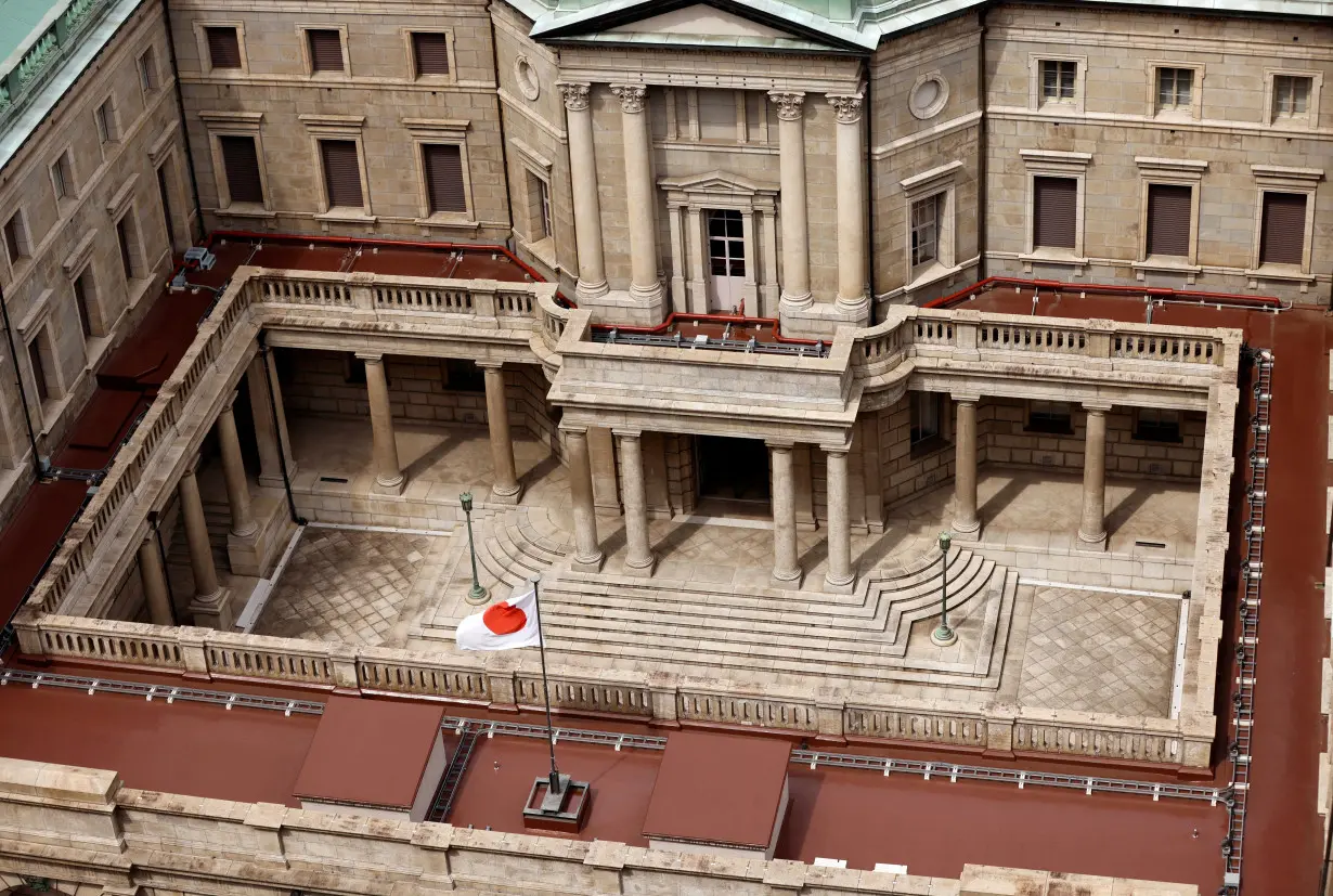 Japanese national flag is hoisted atop the headquarters of Bank of Japan in Tokyo