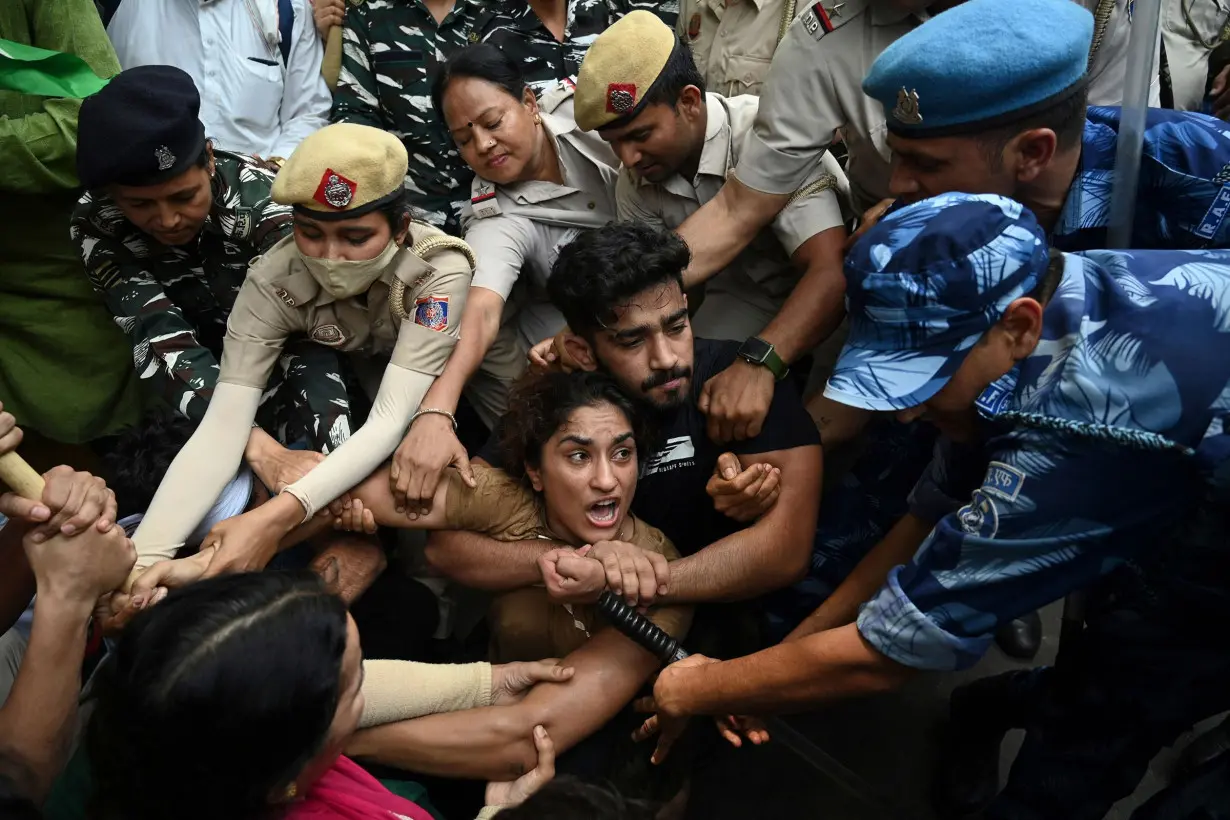 Indian wrestler Vinesh Phogat is detained by the police while attempting to march to India's new parliament, just as it was being inaugurated by Prime Minister Narendra Modi, during a protest against Brij Bhushan Singh, the wrestling federation chief, over allegations of sexual harassment and intimidation, in New Delhi on May 28, 2023.