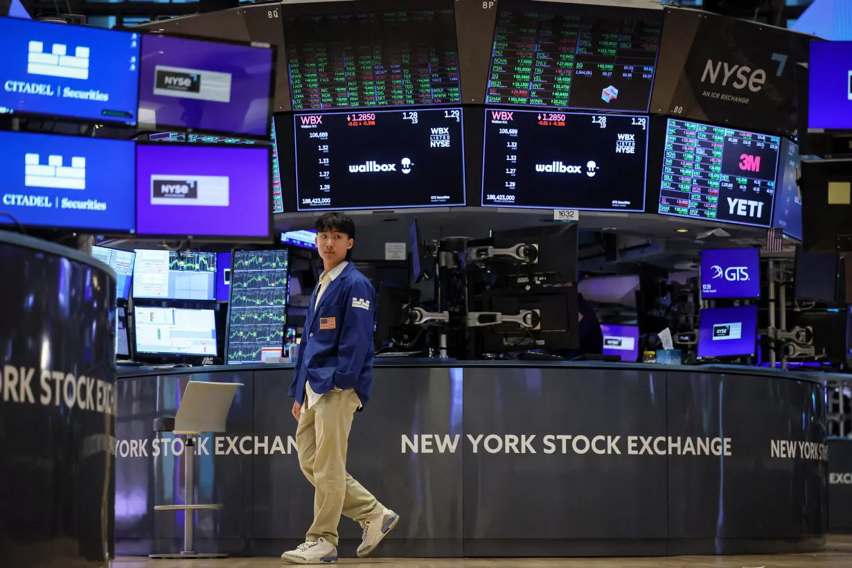 Traders work on the floor of the NYSE in New York