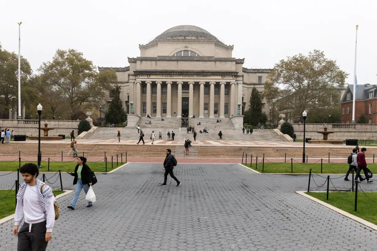 People walk past Columbia University in New York