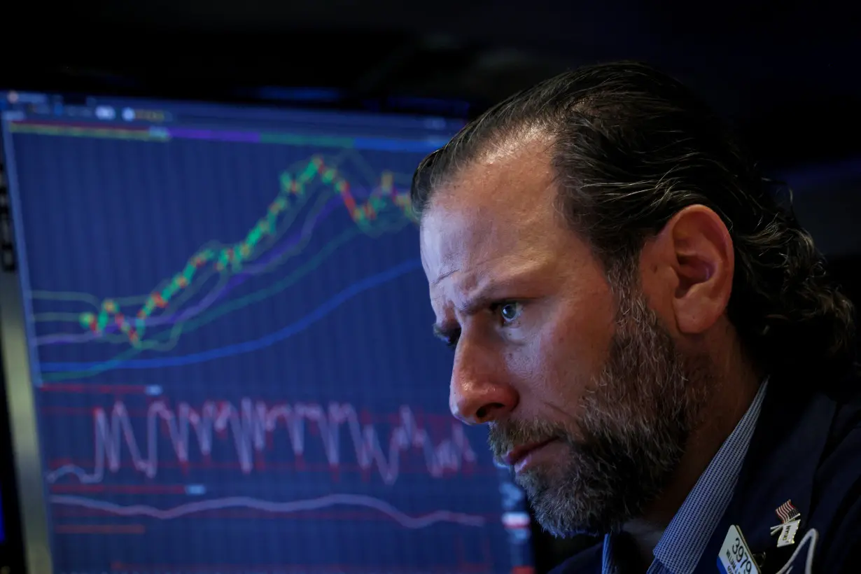 Traders work on the floor of the NYSE in New York