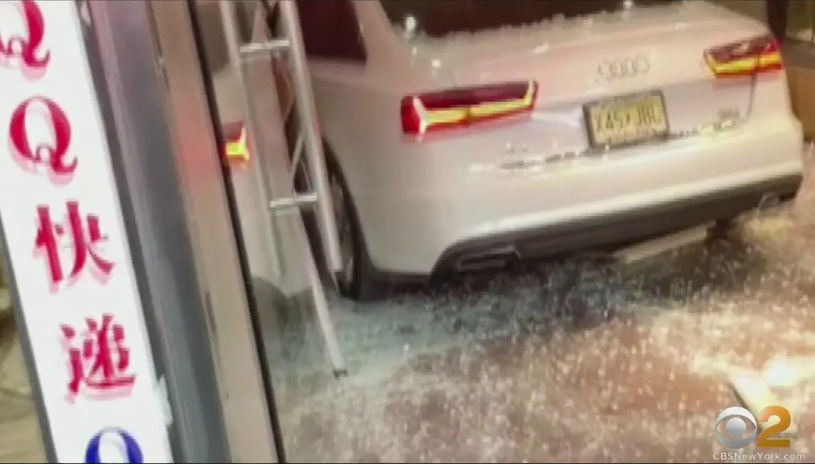 A wild road rage incident caught on video shows a car crashing into a Flushing, NY bakery, followed by a baseball bat fight