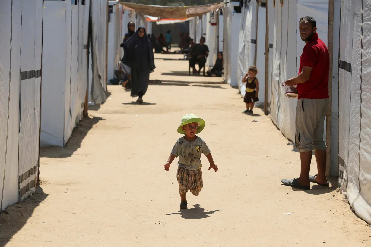 Displaced Palestinians with special needs shelter in a tent camp