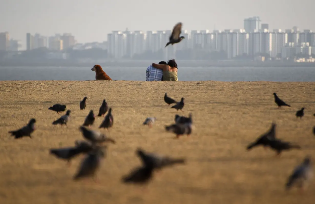 A couple pictured on a beach in Mumbai, India, on February 21, 2023.