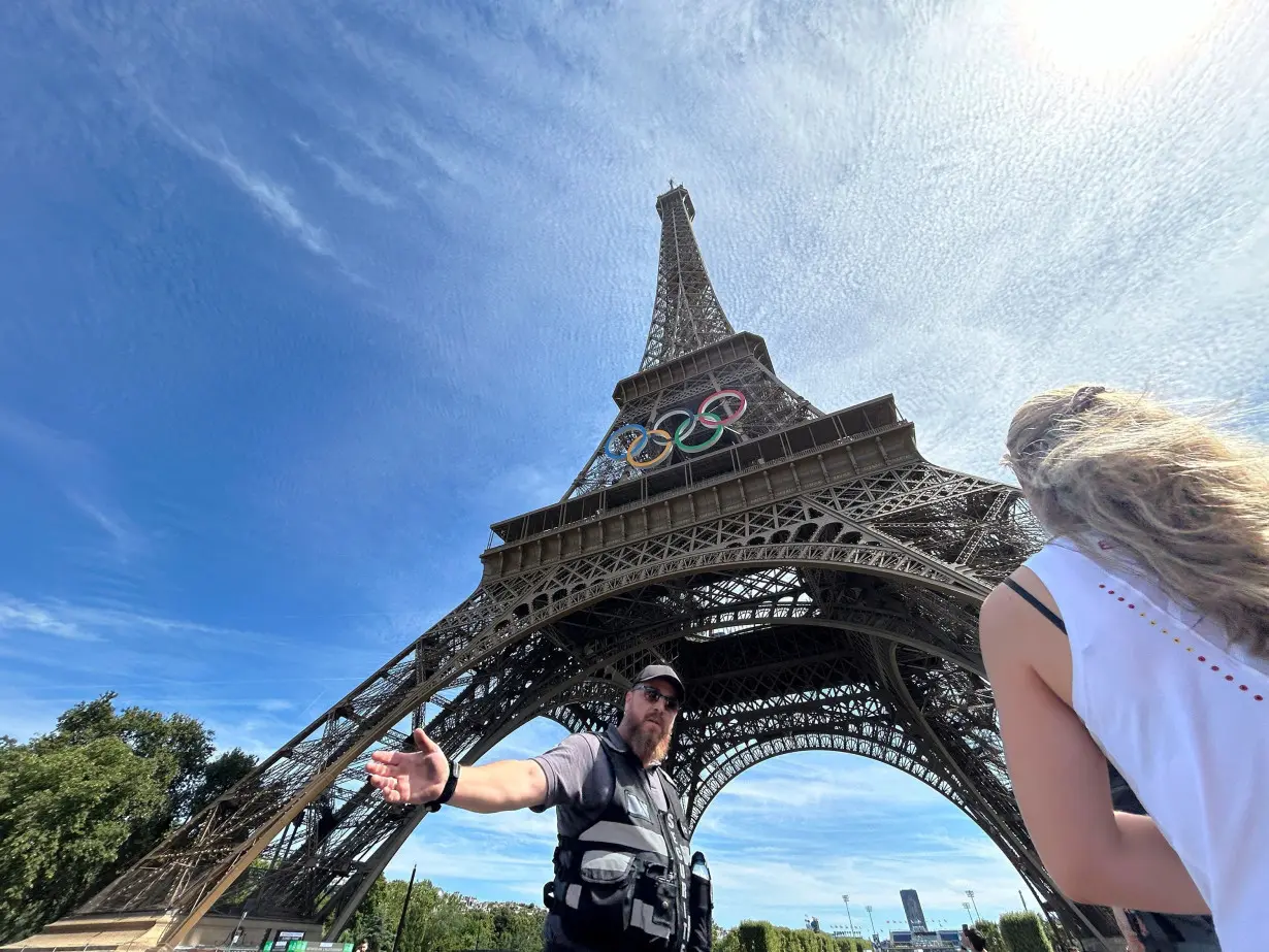 Eiffel Tower evacuated after man seen climbing up the structure, police say