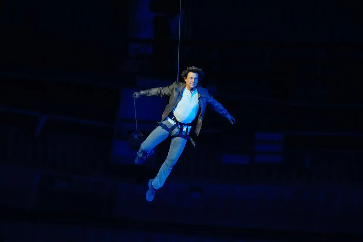 Tom Cruise is lowered on the State de France during the 2024 Summer Olympics closing ceremony on Aug. 11, 2024 in Saint-Denis, France. The 2028 Olympics will be in Los Angeles.