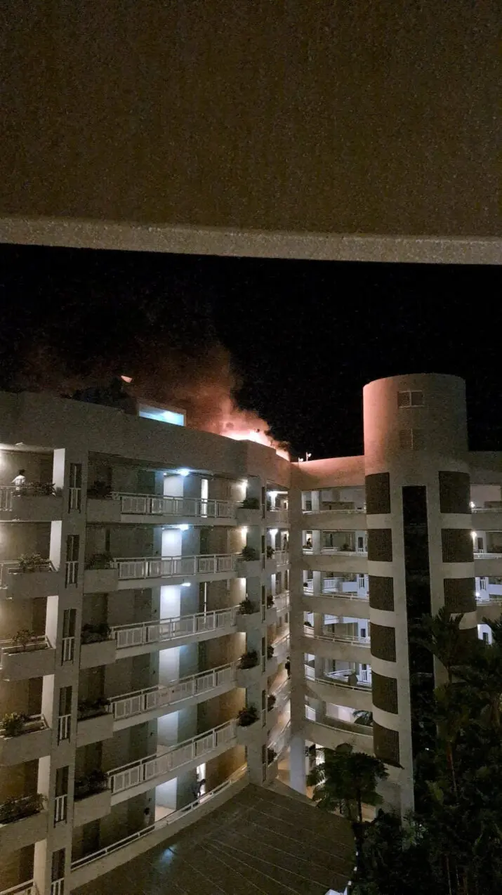 A fire burns at the Double Tree Hotel after a helicopter crashed into the roof in Cairns