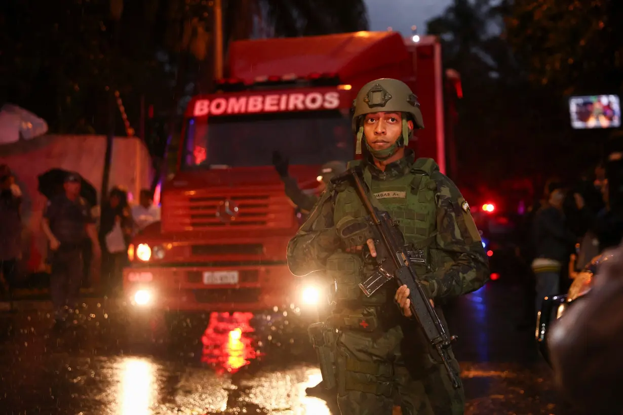 Authorities arrive at the site where a turboprop plane crashed near Sao Paulo