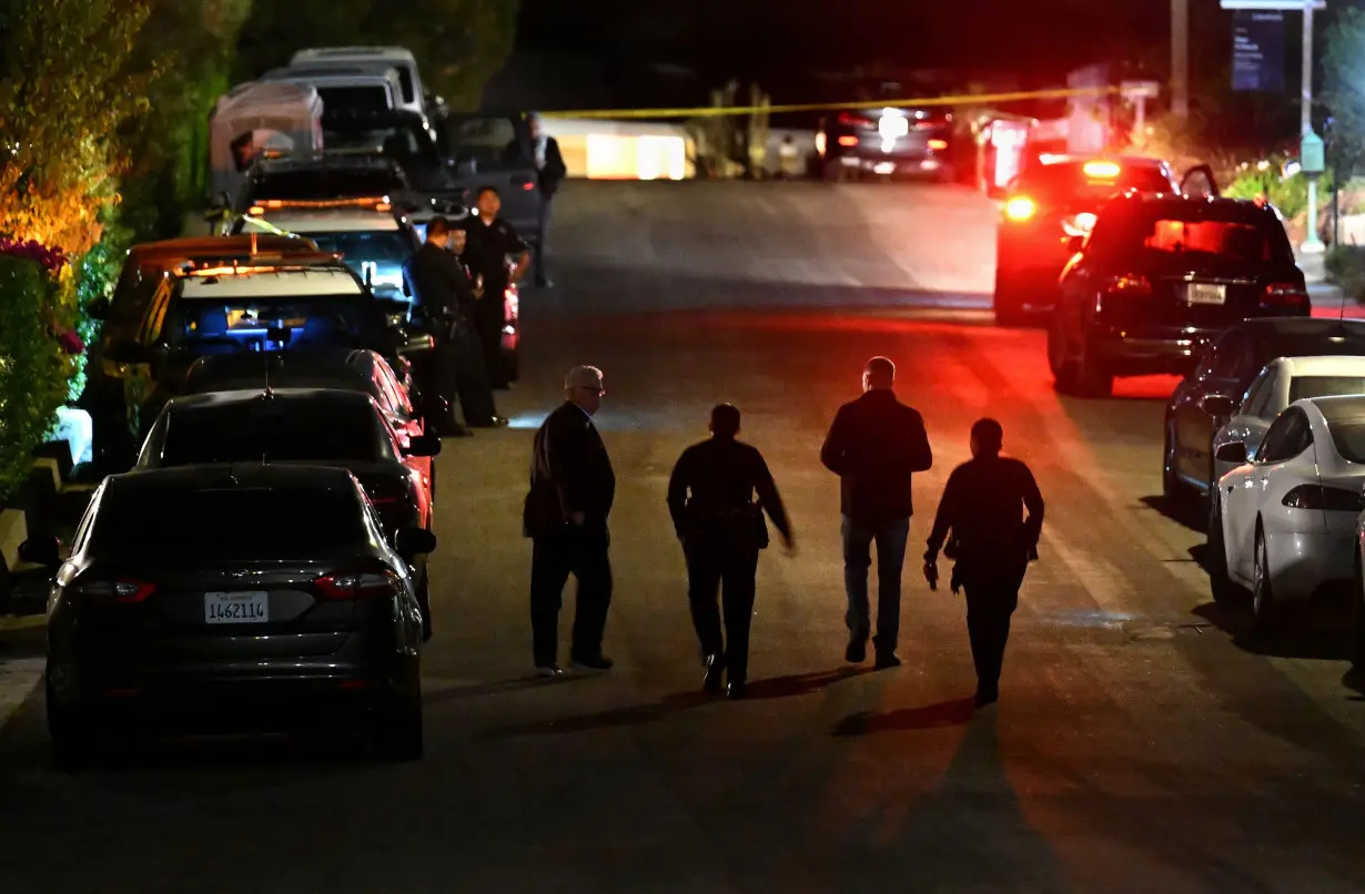 Police investigators walk along the street where Matthew Perry's house was located the night of his death in October 2023.