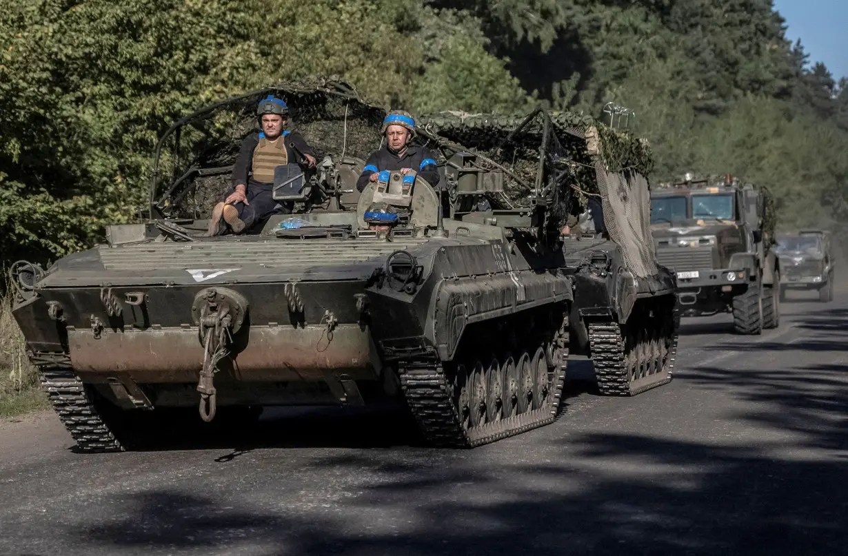 Ukrainian servicemen ride an armoured personnel carrier, near the Russian border in Sumy region, Ukraine.