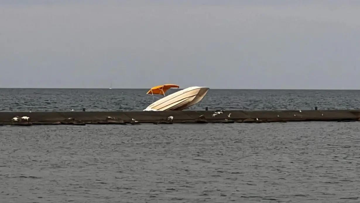 Boat crashes into Holland pier, throws teen into Lake Michigan